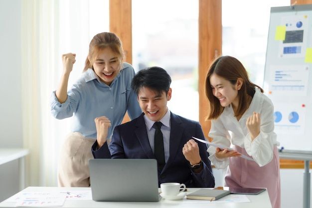 group young asian business people with the creative successful excited raised hands rejoicing premium photo